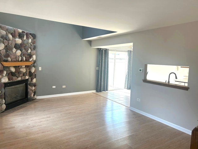 unfurnished living room featuring a fireplace and wood-type flooring