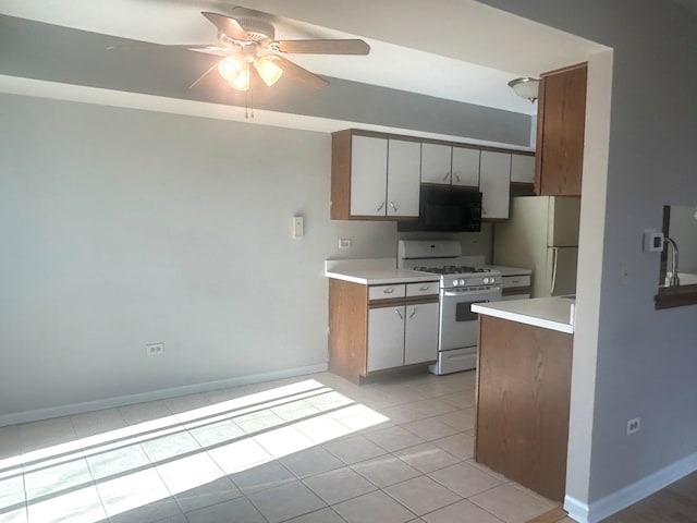 kitchen featuring ceiling fan, light tile patterned floors, and white appliances