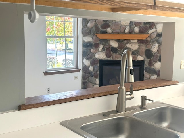 interior details with sink and a fireplace