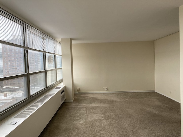 spare room featuring a wealth of natural light, carpet, and a wall mounted AC