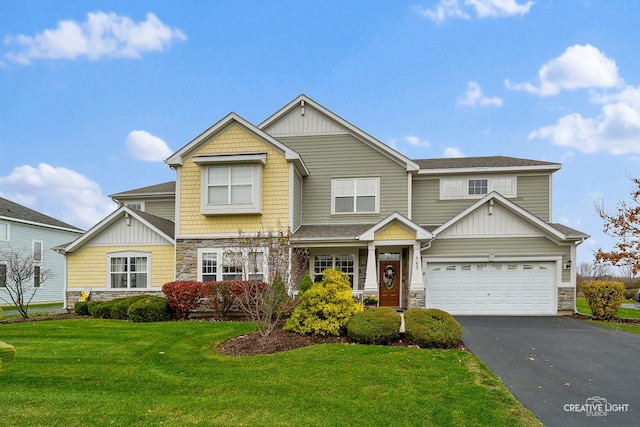 craftsman house featuring a garage and a front lawn