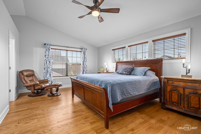 bedroom featuring ceiling fan, light wood-type flooring, multiple windows, and vaulted ceiling