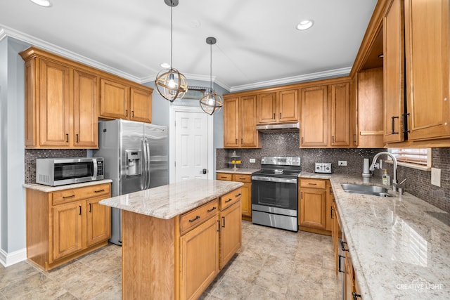 kitchen featuring appliances with stainless steel finishes, light stone counters, sink, a kitchen island, and hanging light fixtures