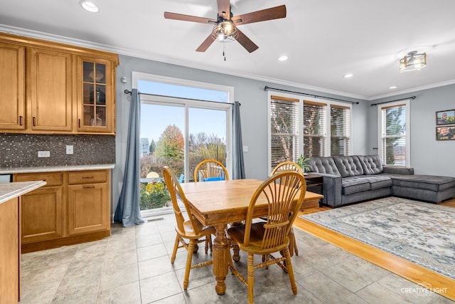 dining room featuring ceiling fan, ornamental molding, and light hardwood / wood-style flooring