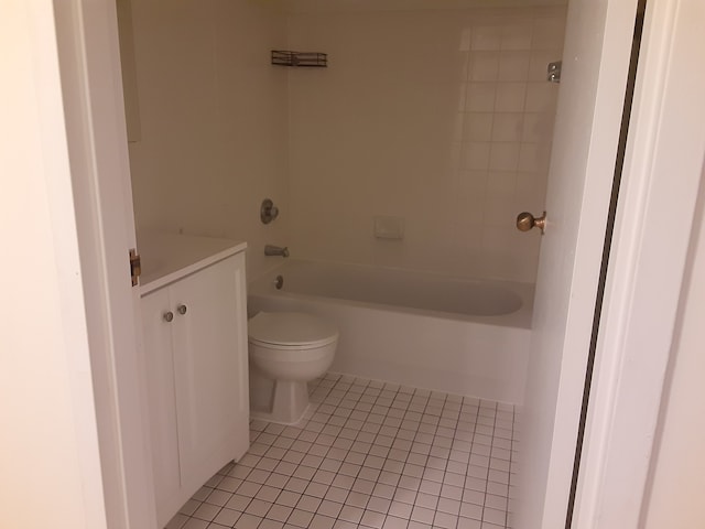 full bathroom featuring tile patterned flooring, vanity, tiled shower / bath combo, and toilet