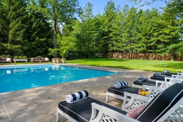 view of swimming pool with a patio and a lawn