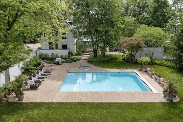 view of swimming pool with a lawn and a patio