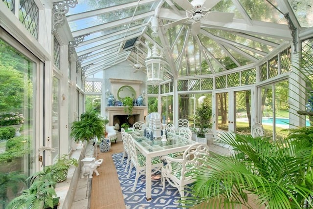 sunroom with ceiling fan and lofted ceiling