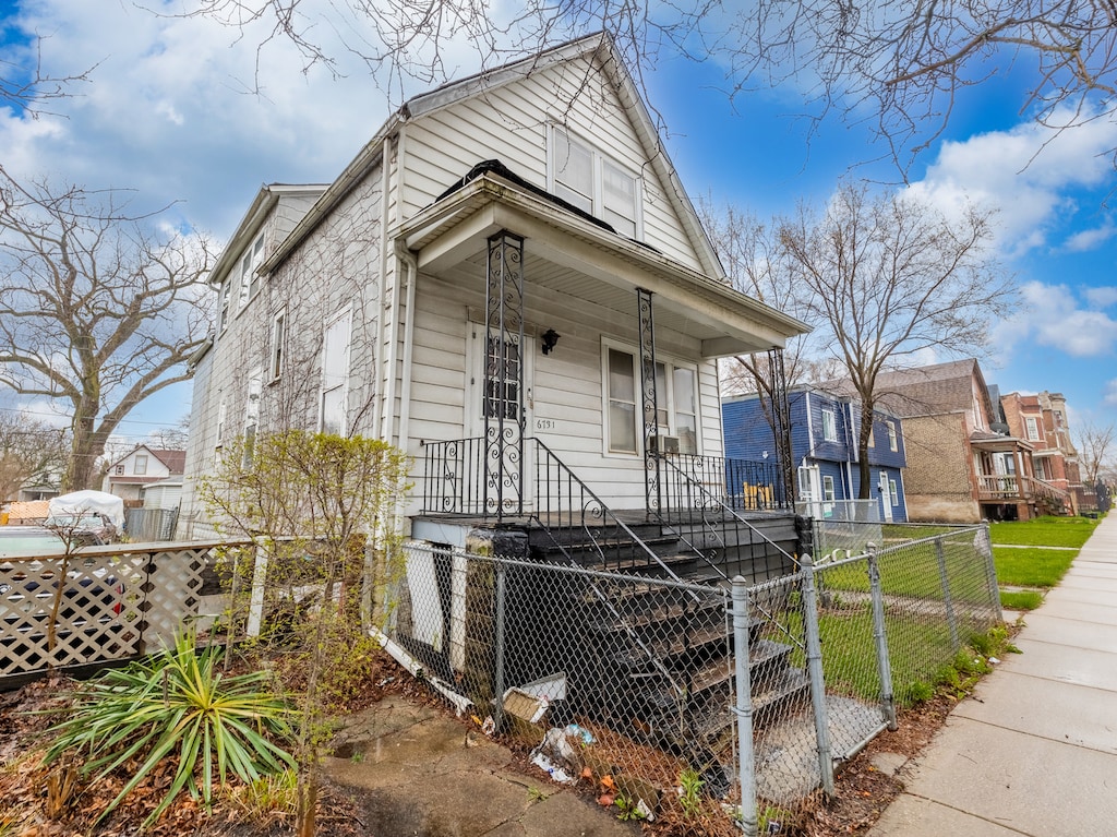 bungalow-style house with a front yard and covered porch