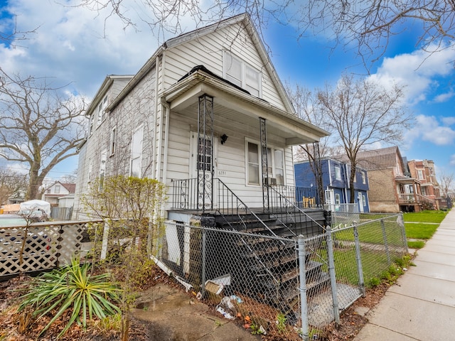 bungalow-style house with a front yard and covered porch