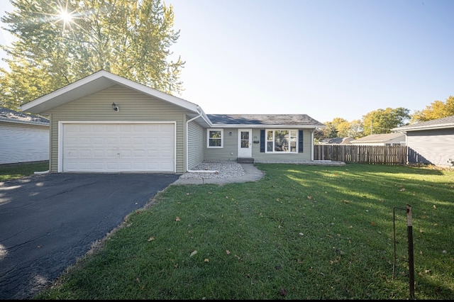 ranch-style house featuring a front yard and a garage