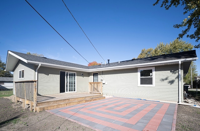 rear view of property with a patio and a wooden deck