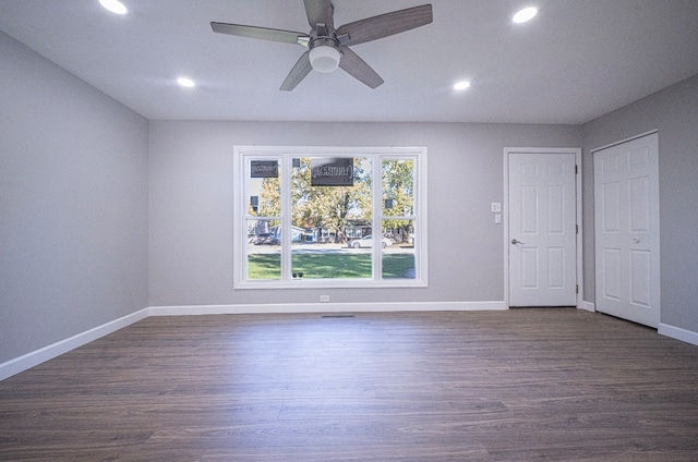 empty room featuring dark hardwood / wood-style floors and ceiling fan