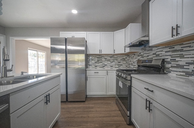 kitchen with sink, white cabinets, wall chimney range hood, and stainless steel appliances