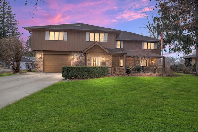 view of front of home featuring a garage and a lawn