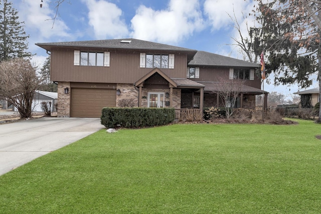 view of front of house with a garage and a front yard