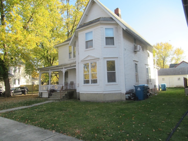 victorian home featuring a porch and a front lawn