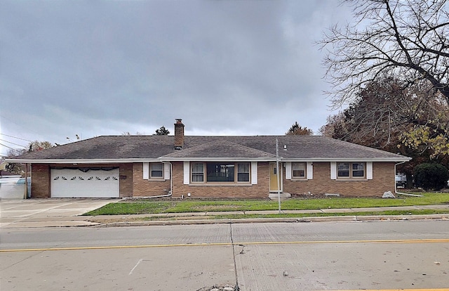 ranch-style home with a garage and a front yard