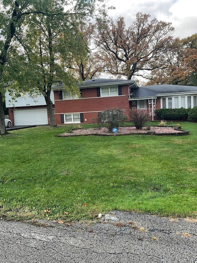 view of front of property featuring a front yard and a garage