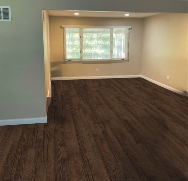 unfurnished room featuring dark wood-type flooring