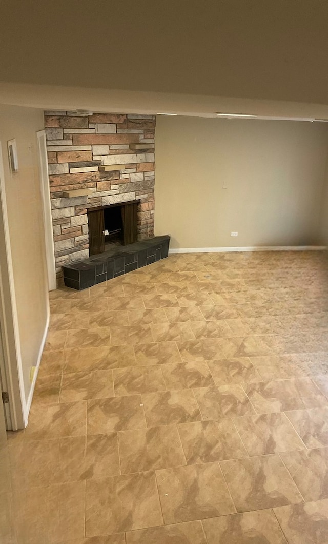 unfurnished living room featuring a stone fireplace