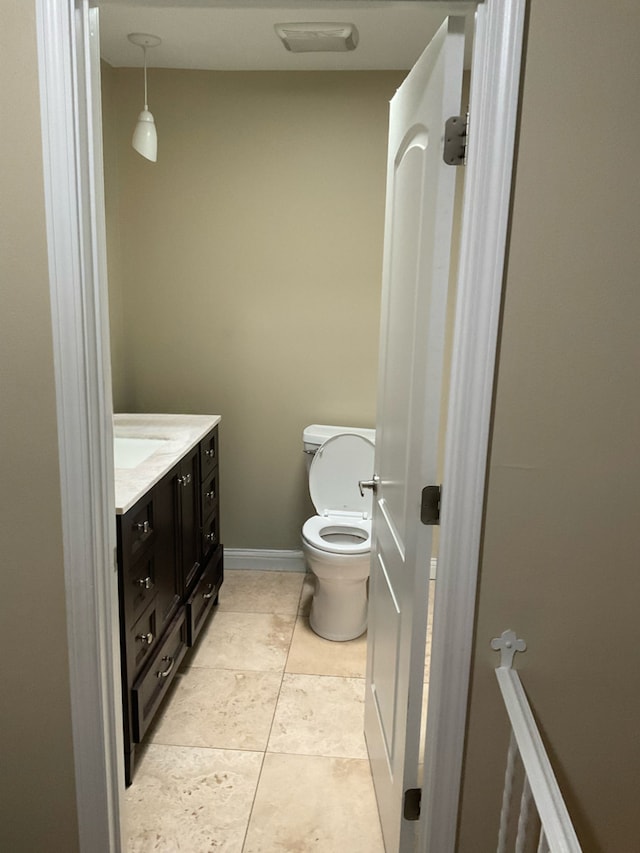 bathroom featuring vanity, toilet, and tile patterned floors