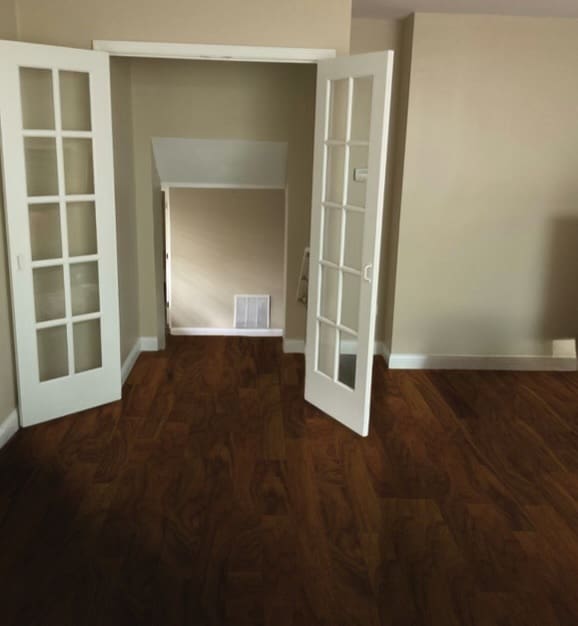 unfurnished room featuring dark wood-type flooring and french doors