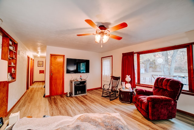 living room with light wood-type flooring and ceiling fan