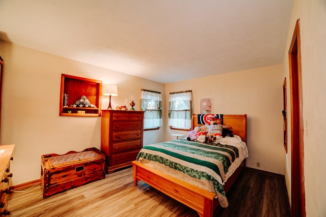 bedroom with hardwood / wood-style flooring