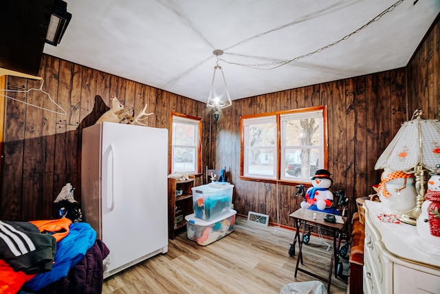 miscellaneous room with wood walls and light hardwood / wood-style flooring