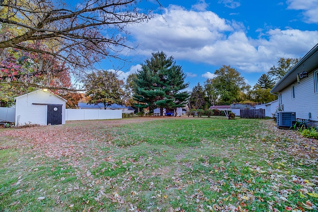 view of yard featuring central AC and a shed