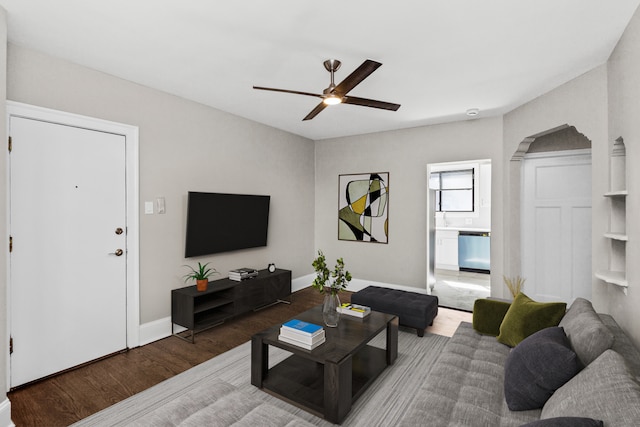 living room featuring ceiling fan and hardwood / wood-style flooring