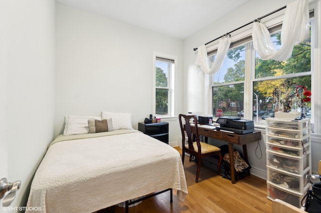 bedroom with hardwood / wood-style flooring