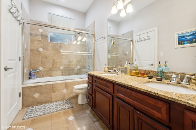 full bathroom with vanity, toilet, tile patterned floors, and combined bath / shower with glass door