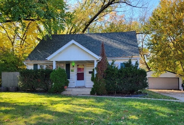 view of front of house featuring an outdoor structure, a front lawn, and a garage