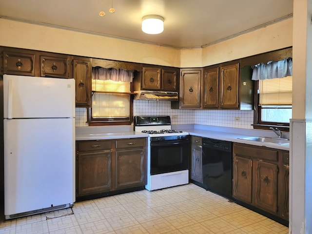 kitchen with white appliances, dark brown cabinets, decorative backsplash, and sink