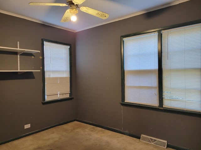 empty room featuring ornamental molding, light colored carpet, and ceiling fan