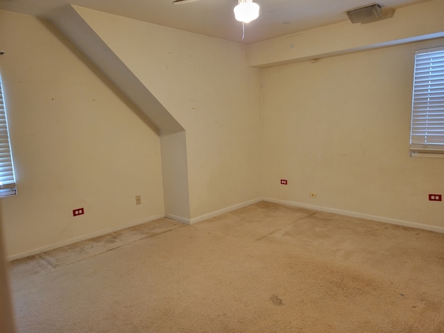 additional living space featuring carpet floors and ceiling fan