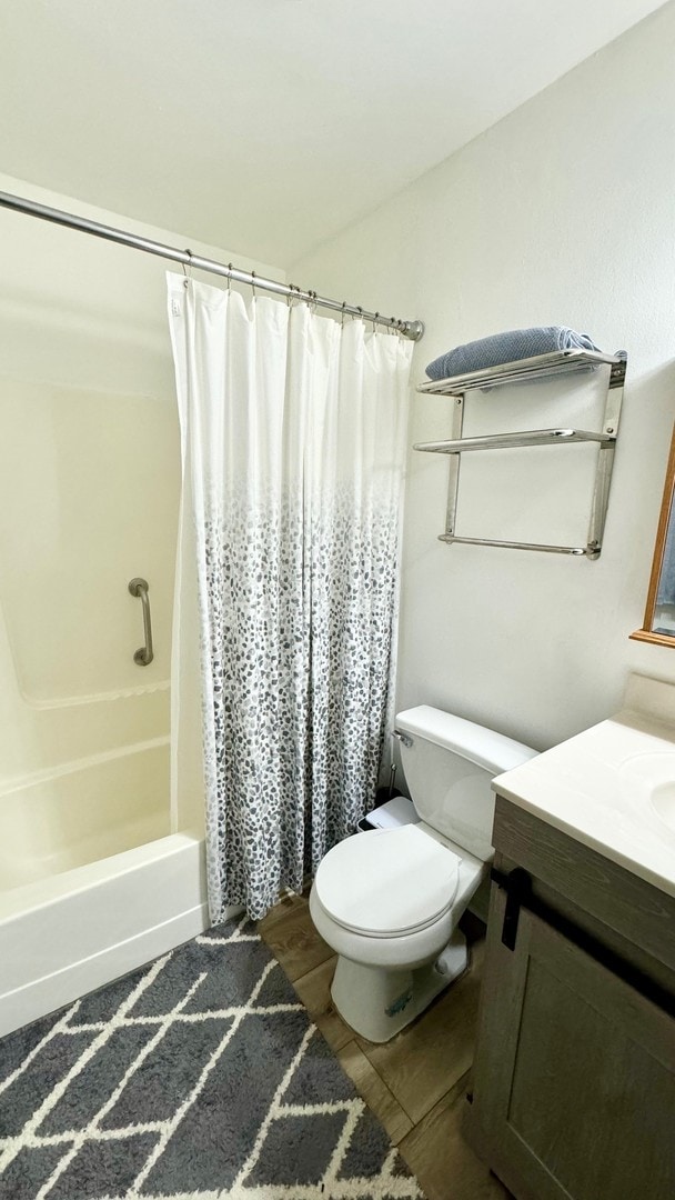 full bathroom featuring vanity, toilet, and shower / bathtub combination with curtain