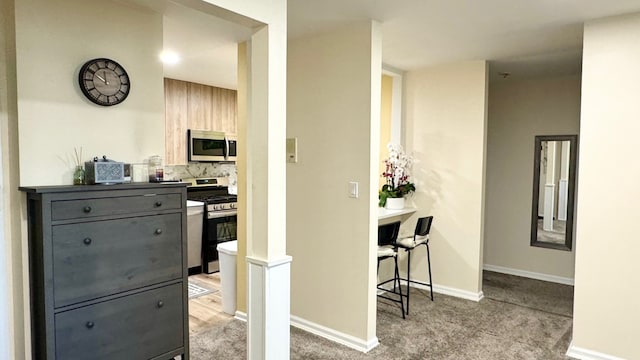 interior space with appliances with stainless steel finishes and decorative backsplash