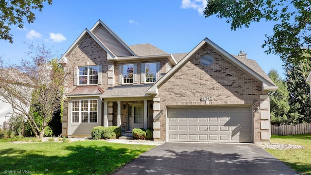 view of front of house featuring a front yard and a garage