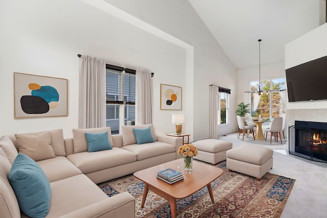 living room with a notable chandelier and high vaulted ceiling