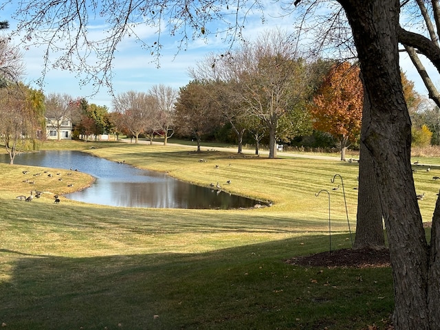 surrounding community featuring a yard and a water view