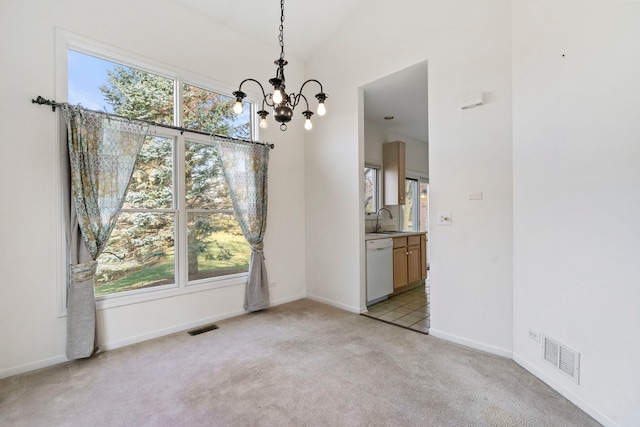 unfurnished dining area with light carpet, a healthy amount of sunlight, and sink