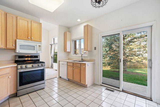 kitchen with sink, white appliances, and light tile patterned floors