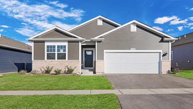 craftsman-style house with a front yard and a garage