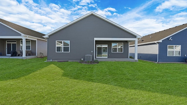 rear view of property with a patio area and a lawn