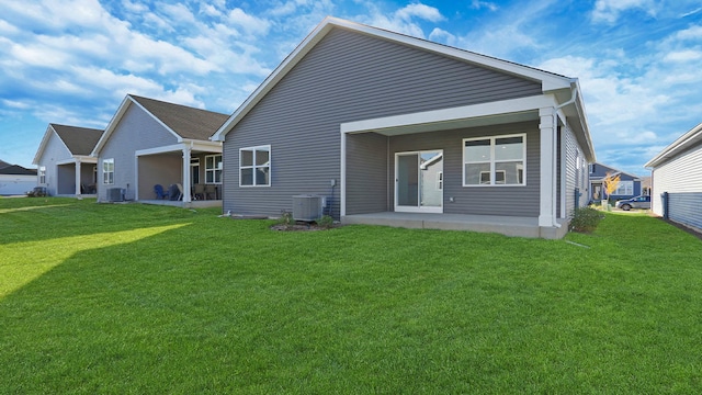 rear view of house featuring a yard and central AC