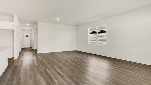 empty room with dark wood-type flooring