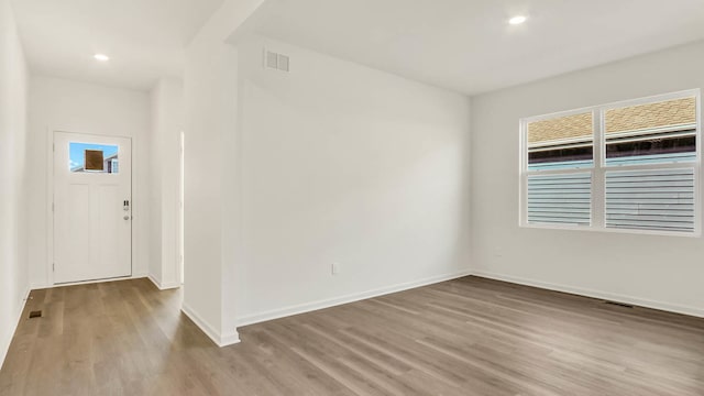 unfurnished room with light hardwood / wood-style floors